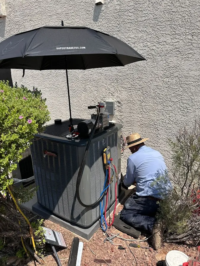 HVAC technician performing outdoor AC maintenance in Covington